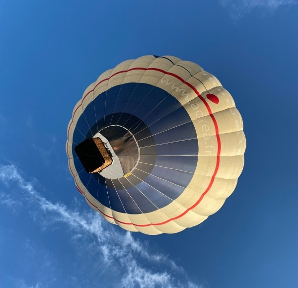 Hot air balloon taken from below in the blue sky