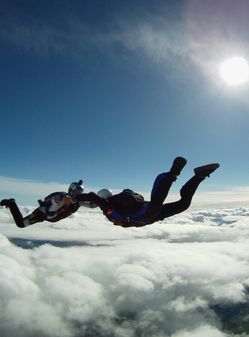 Solo skydiving with blue sky and sun