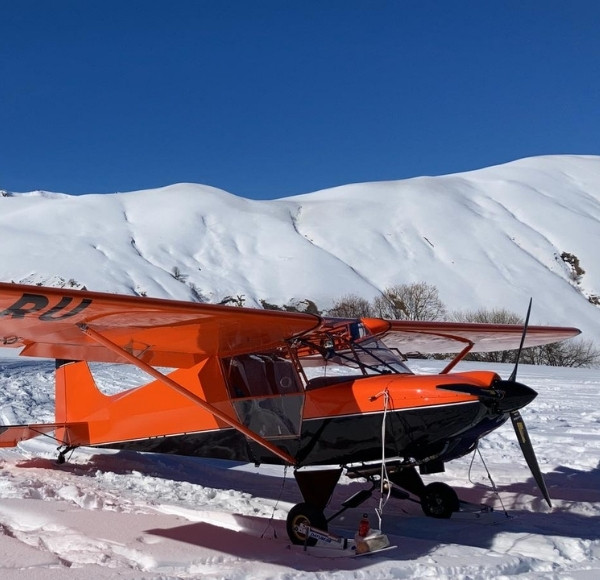plane on snowy mountain high alps