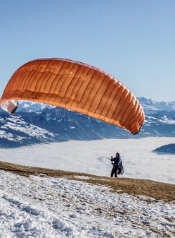 winter paragliding flight with skis